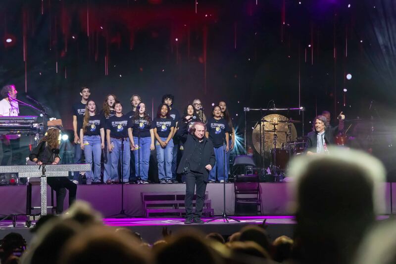 Pictured: Members of the St. Petersburg Collegiate High School Student Choir sing I Want To Know What Love Is with Foreigner and original lead singer Lou Gramm.