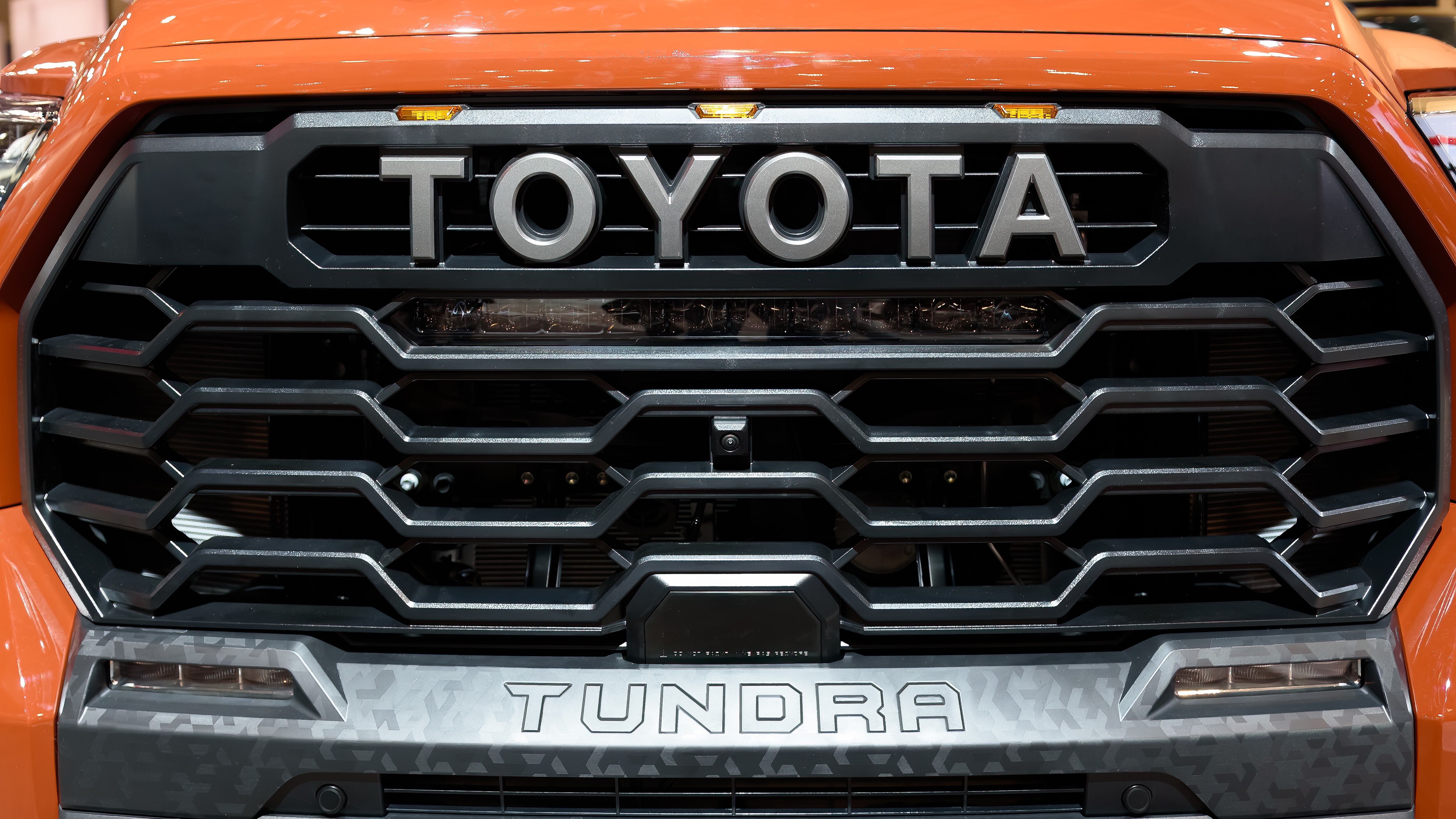 The word Toyota in the grille of a Tundra vehicle or car