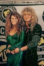 1987: Rocker David Coverdale of the rock group "Whitesnake" poses with his girlfriend, Tawny Kitaen, at the 1987 MTV Music Awards at Universal City, California. Kitean made a name for herself in the 1980s by appearing in several "Whitesnake" videos.
